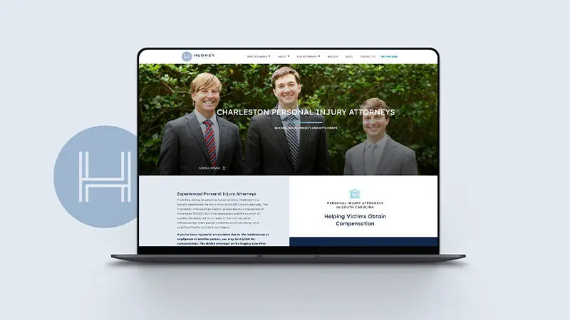 home screen website design mocked up on a laptop next to the hughey law logo