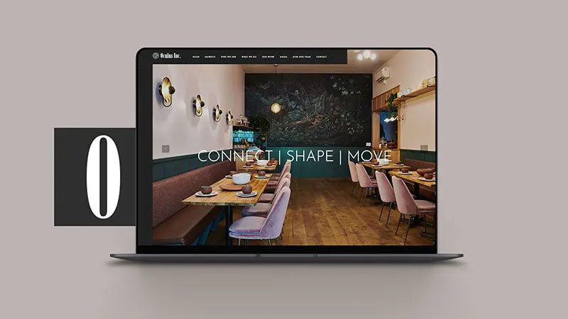 home screen website design mocked up on a laptop next to the oculus logo