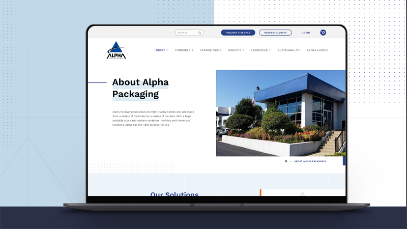 home screen website design of alpha packaging mocked up on a laptop with a blue background