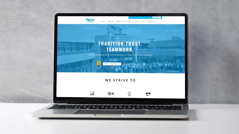 Laptop displaying the Tacony Corporation website homepage, highlighting the company's family of brands and commitment to tradition, trust, teamwork, and business innovation.
