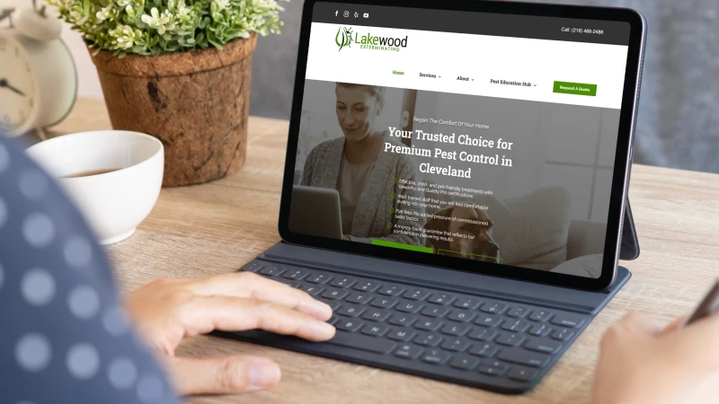 Person browsing the Lakewood Exterminating website on a tablet from a home setting.