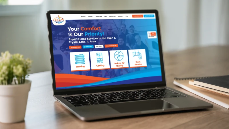 Laptop on a wooden desk displaying an HVAC service homepage with icons for Heating, Cooling, Indoor Air Quality, and Duct Service.