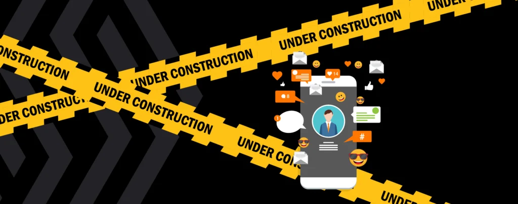Under Construction tape with a mobile phone featuring a social media profile