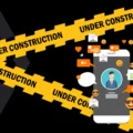 Under Construction tape with a mobile phone featuring a social media profile