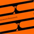 Abstract orange and black graphic featuring a stylized search bar with the words ‘Keyword Research’ and a magnifying glass icon, symbolizing SEO and digital search concepts.