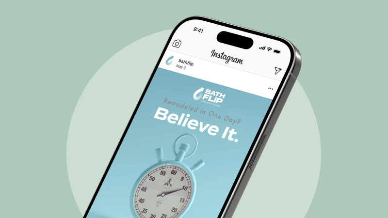 Tilted smartphone displaying an Instagram post with a blue Bath Flip ad that says 'Believe It' and features a stopwatch image.