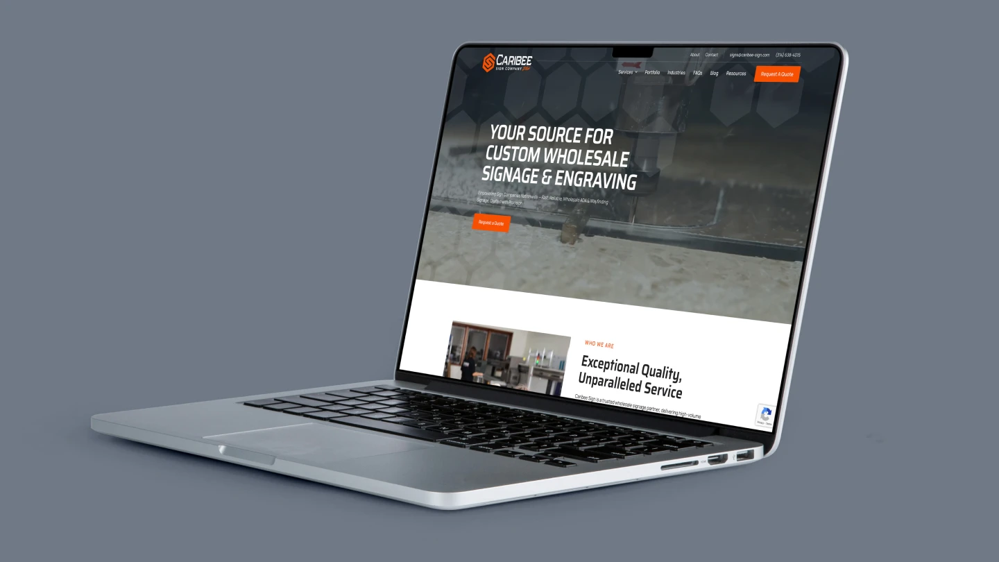 A silver laptop displays a website with the text "Your Source for Custom Wholesale Signage & Engraving." The tone is professional and informative.