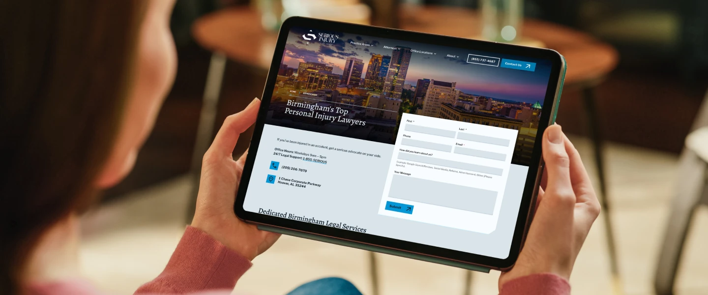 Tablet displaying Serious Injury Law Group contact form and Birmingham personal injury lawyer information for quick inquiry submission