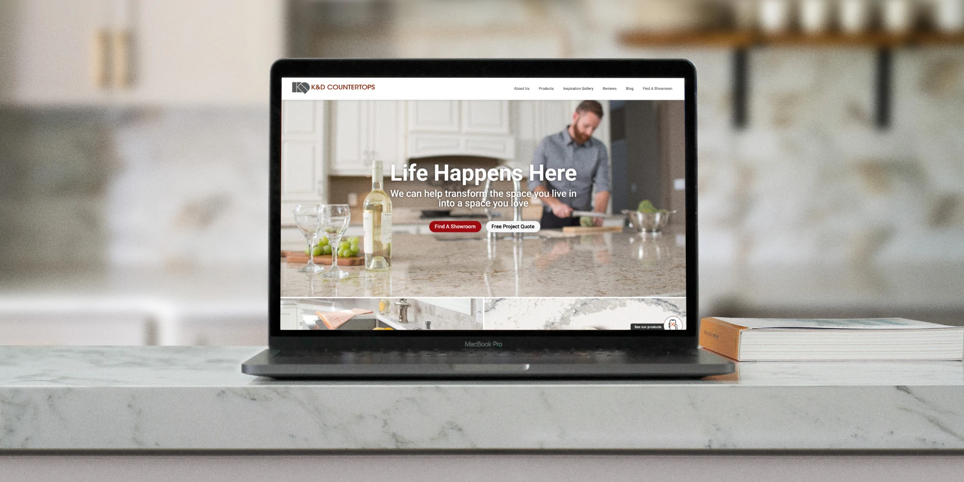 Laptop sitting on Cambria countertops featuring the K&D Countertops website