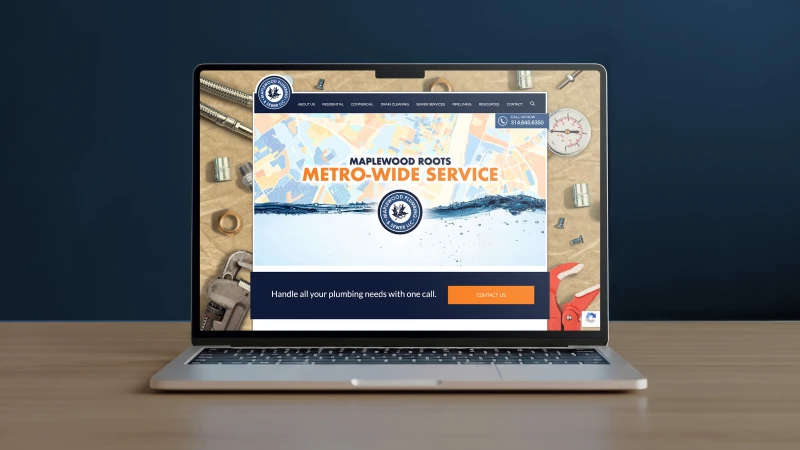 A laptop on a wooden table displays a plumbing service website with a banner reading "Maplewood Roots Metro-Wide Service." The tone is professional.
