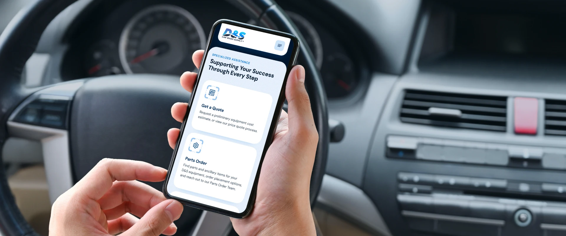 Person holding a smartphone in a car, displaying a service app with options like Get a Quote and Parts Order on the screen.