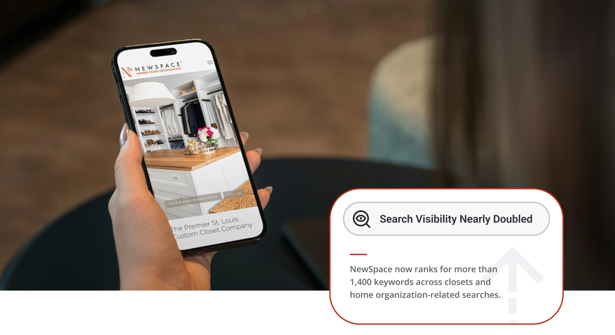 Hand holding a phone displaying a closet organization app with shelves and clothes visible on screen, NewSpace branding at top.